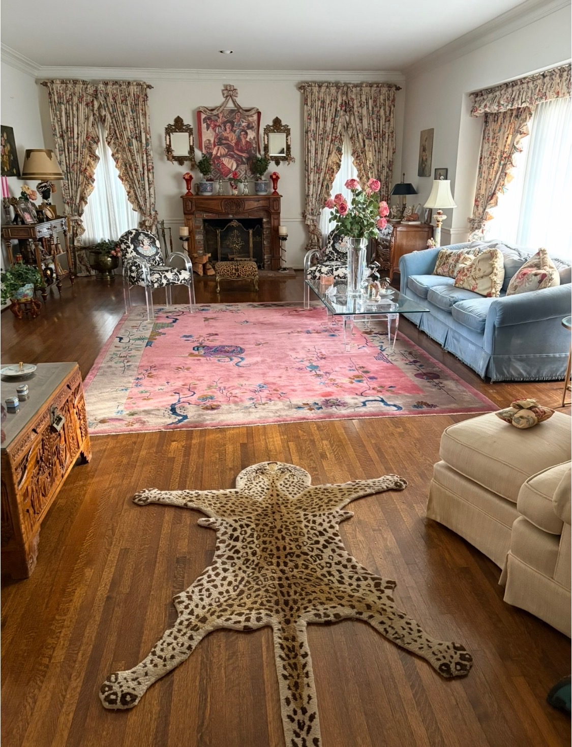 Beverly Hills salon by Goodman Interiors — pink Chinese rug, leopard hide on wood floor, blue velvet sofa and floral curtains